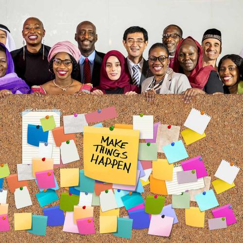 people holding a board with sticky notes