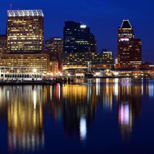 Baltimore Maryland is reflected in the waters of Inner Harbor